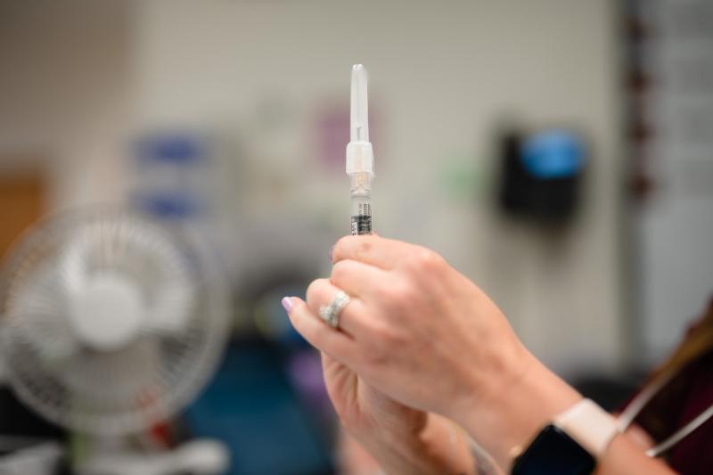 hands holding a syringe